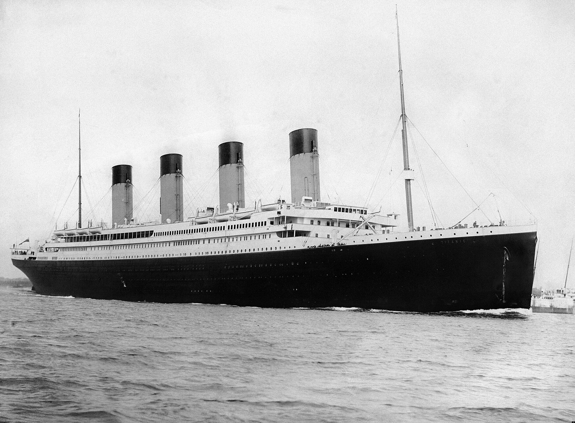 RMS Titanic photographed from the quayside as she leaves Southampton with tugs alongside
