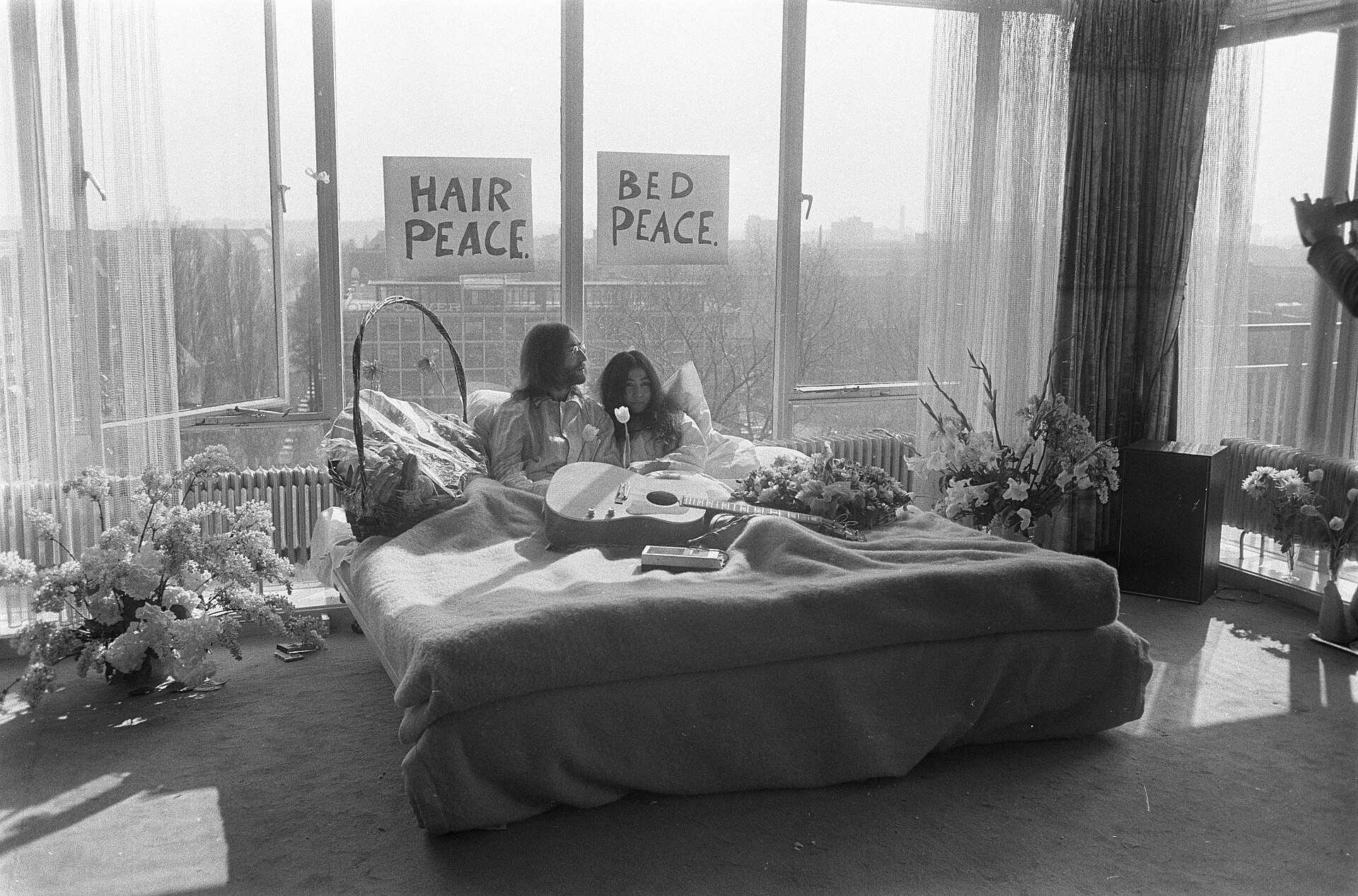 John Lennon and Yoko Ono speaking to reporters from their hotel bed in Amsterdam in March 1969